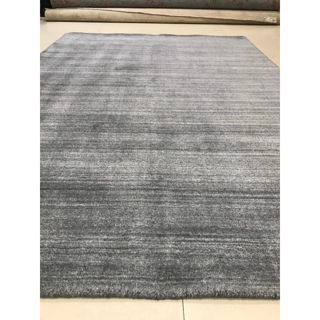 Handmade rug in wool and viscose.