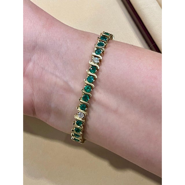 Approximately 6 Carat Emerald And 1.5 Carat Diamond Tennis Bracelet 14 Karat Yellow Gold Total weight of Emerald is...