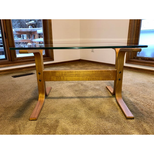 One authentic Ingmar Relling Siesta glass side table with teak frame. The glass and frame are in excellent condition. The...