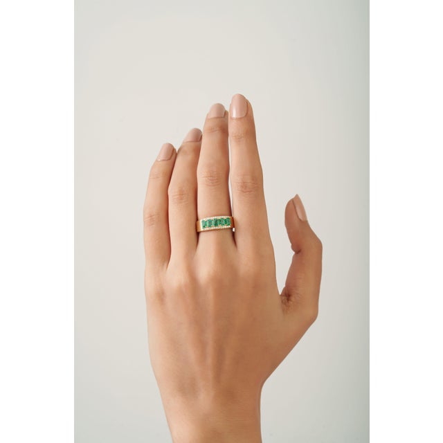 This unisex band ring featuring a 1.01 carat crafted in 14K yellow gold. Each stone measures approximately 3.99 x 2.92 mm...