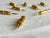 Vintage Hollywood Regency set of eight gilt bamboo corn on the cob holders, presented in the original vibrant olive green...