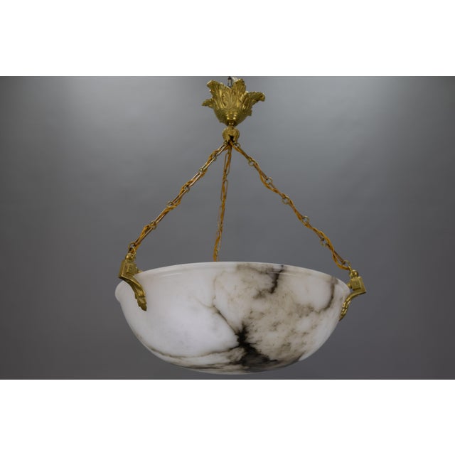 French Neoclassical-style pendant light made of black veined white alabaster with bronze fixtures. This stunning ceiling...