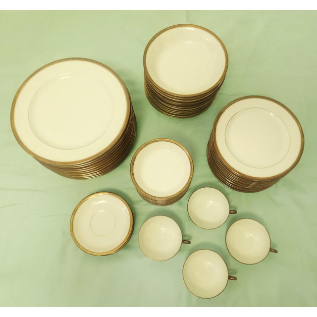 Exquisite Limoges porcelain dinnerware set from the 1920, fine simplicity white plates and bowls with textured gold rims,...
