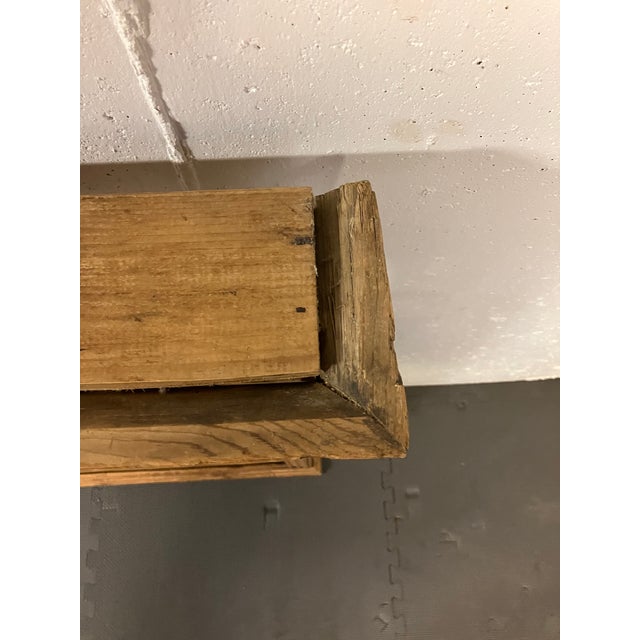 An English pine plate rack dating to the 19th century, featuring three open tiers for display and storage. The rack is...