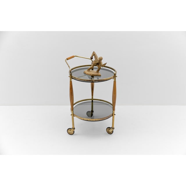 Mid-Century Modern Regency Style Serving Trolley in Smoked Glass and Wood, 1960s, in Good conditions. Designed 1950 to 1959