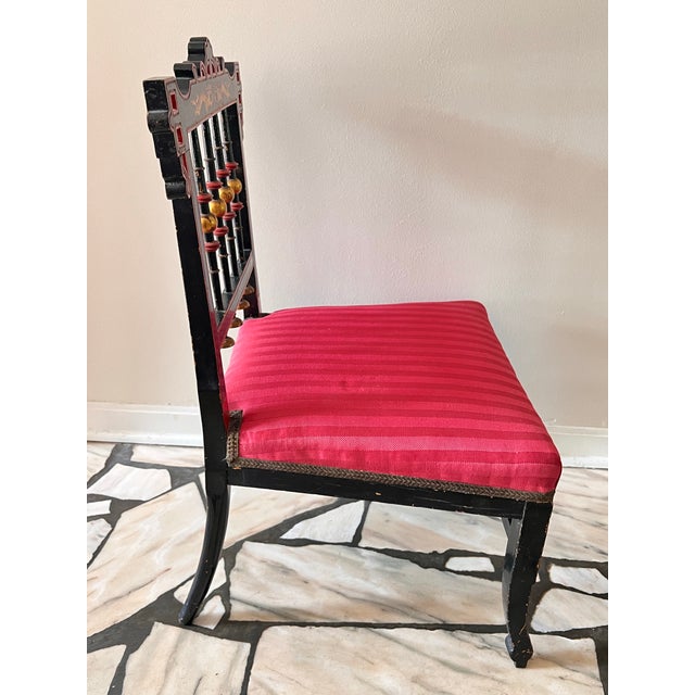 This is a gorgeous antique slipper chair that has a lovely Chinoiserie style and that has intricate details on the...
