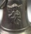 A decorative cast bronze bell featuring a detailed relief of a winged cherub or angel on its exterior. Very heavy piece...