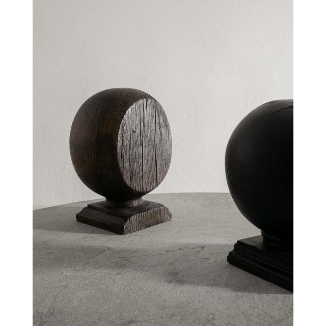 Pair of british antique wooden sculpture globes in black and dark brown stained wood. In good vintage condition....