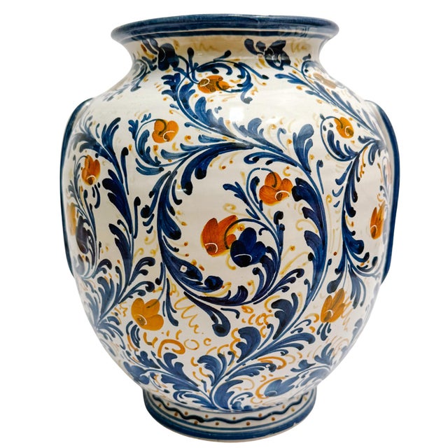 A striking vintage Italian Majolica vase featuring a bold heraldic shield, vibrant hand-painted scrollwork, and classic...