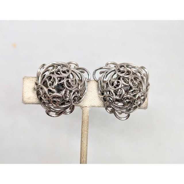 1960s rhodium plated domed ferns clip back earrings. Marked "Napier." Measure: 1 inch long by 1 1/8 inches wide. Excellent...