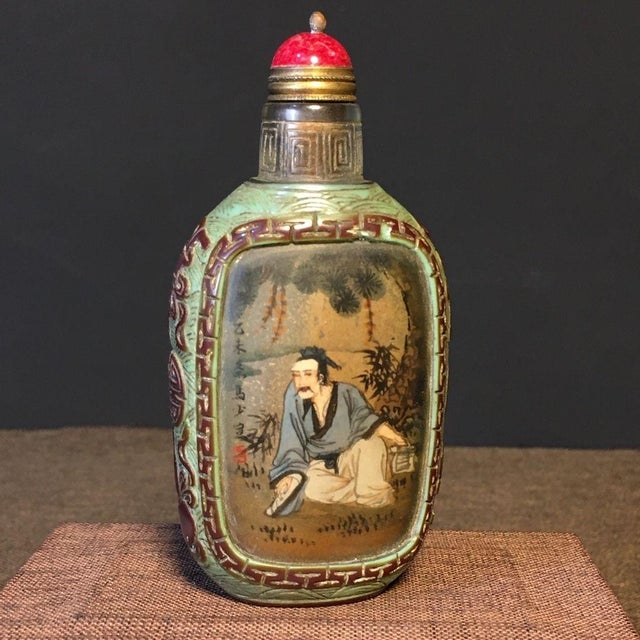 This is a charming vintage Chinese snuff bottle, crafted from Liuli (traditional Chinese glass) with an inner-painted...