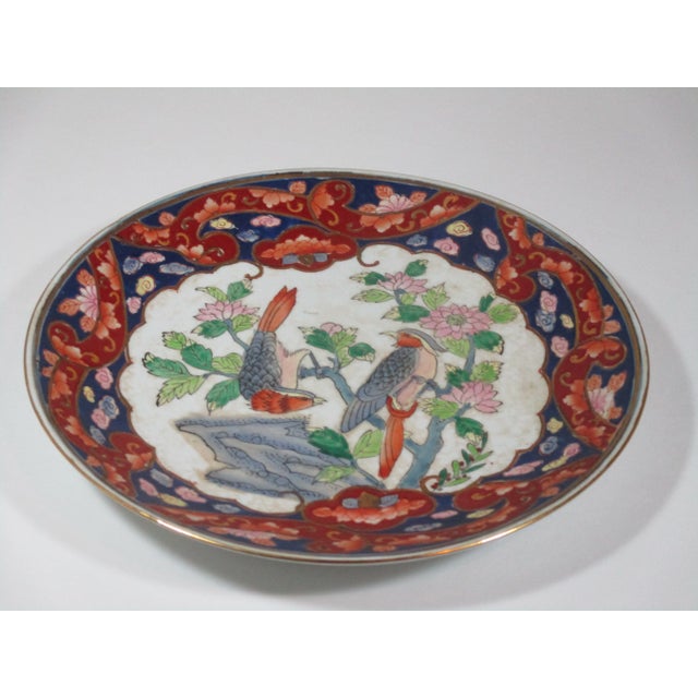 Vintage hand painted porcelain Imari style plate, painted in colors of red, blue, rose, green and gray with gold accents....