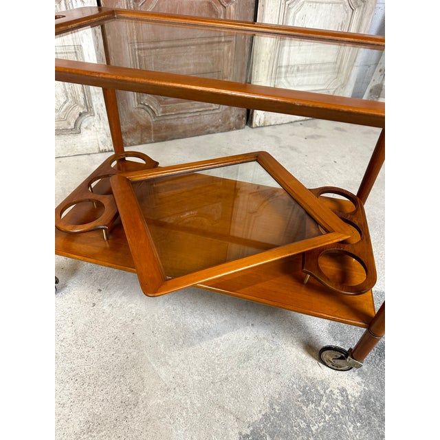 Rolling serving table in stained wood, 1960-70 period in the style of cesare lacca. Bottle holder and removable tray in...