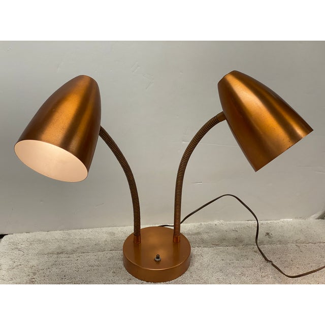 Vintage 50's steel double gooseneck desk lamp with rare brushed copper finish. Features flexible necks that adjust to any...