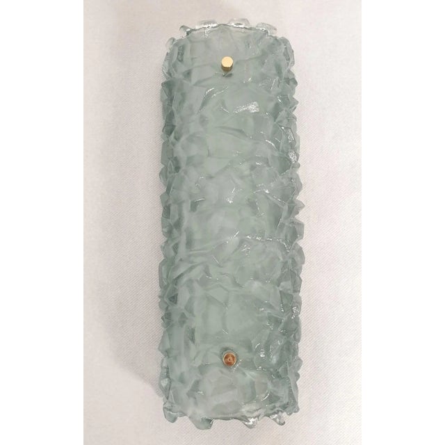 Pair of Mid Century Modern Murano glass sconces, Mazzega style, Italy 1980s. The pair of long sconces is made of a thick...