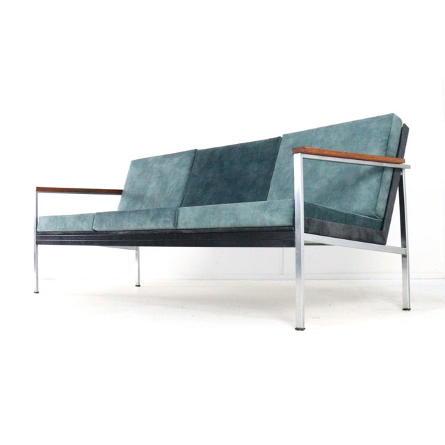This elegant sofa, model 1741 with armrests, was designed in 1967 by Coen de Vries for the Dutch furniture company Gispen....