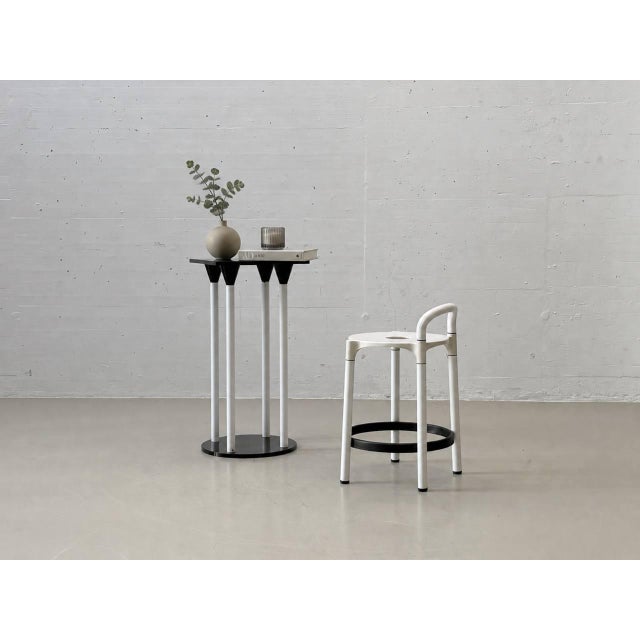 A rare postmodern set by kartell, consisting of the model 4581 standing table and two matching polo bar stools, designed...