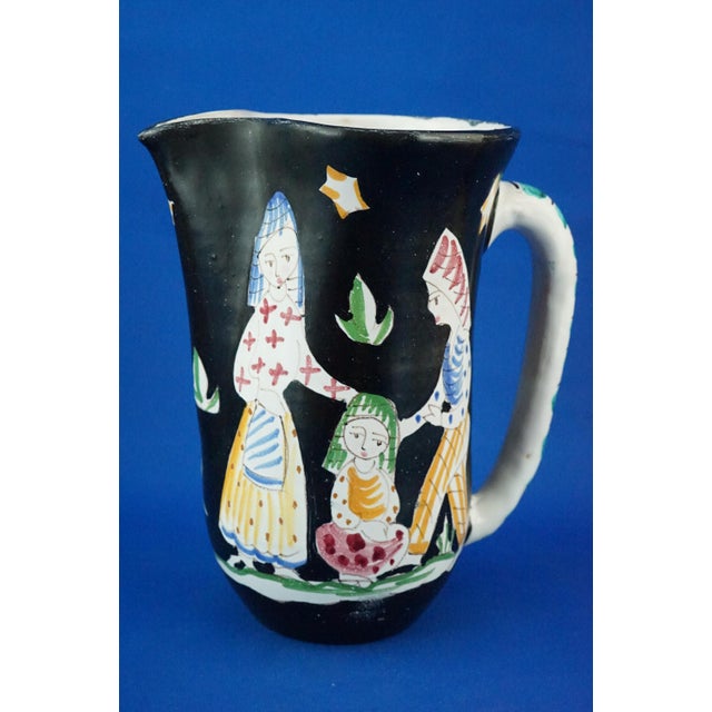 Item description: Large jug with a three-lobed spout, made of glazed and vitrified majolica ceramic, entirely modeled on a...