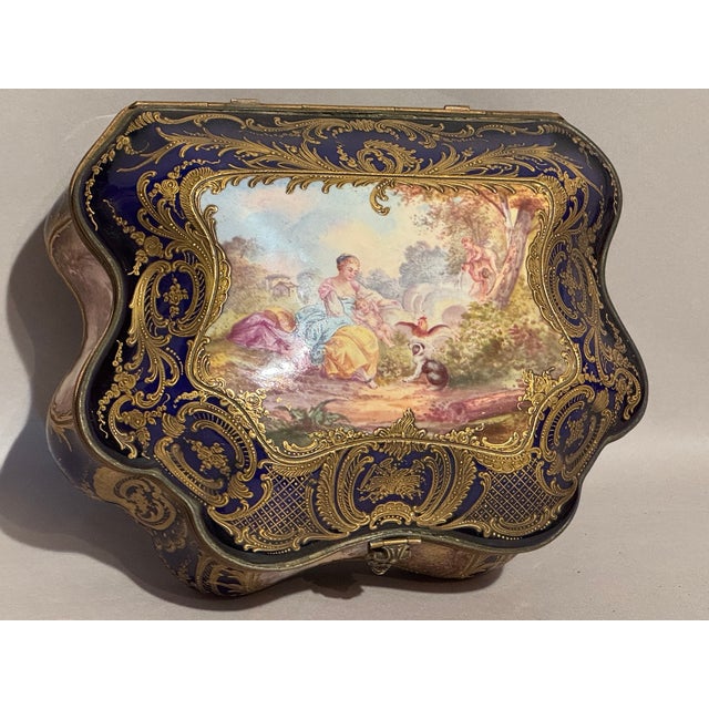 This exquisite circa 1860s French Sèvres porcelain jewelry box is a richly decorated example of Rococo Revival design from...