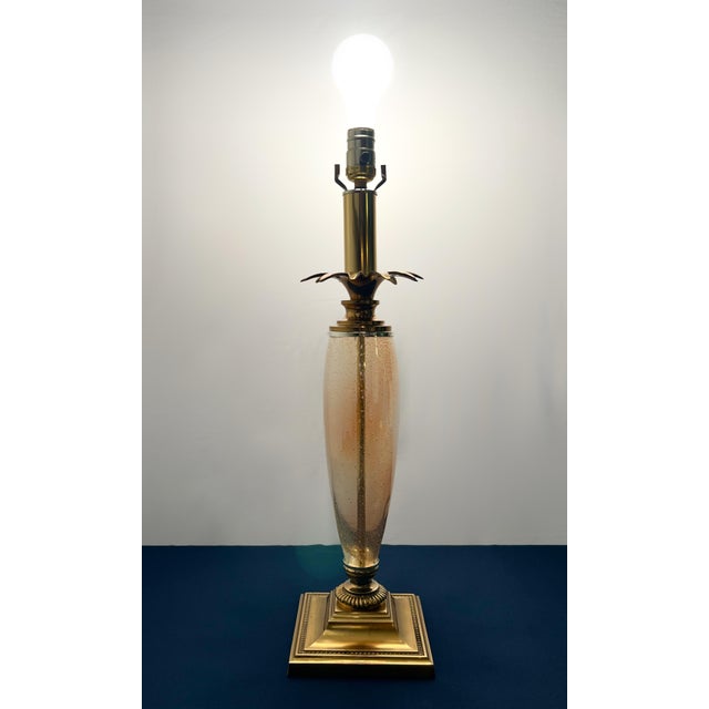 A striking Hollywood Regency statement piece attributed to Speer Fine Lighting. This lamp features a tall amber-toned...