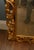Italian giltwood wall mirror, beautifully hand carved in the Rococo manner with an elegant arched mirror plate set within...