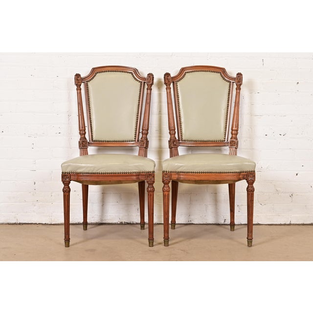 A gorgeous pair of French Regency Louis XVI style side chairs or dining chairs In the manner of Baker Furniture USA,...
