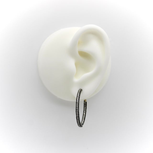 These 18k white gold hoop earrings contain 330 diamonds in an “inside out” setting that puts every diamond in a visible...