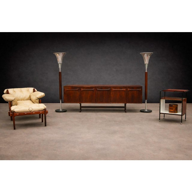 Attributed to an unknown Brazilian workshop and produced in the 1950s, this pair of torchière floor lamps exemplifies...