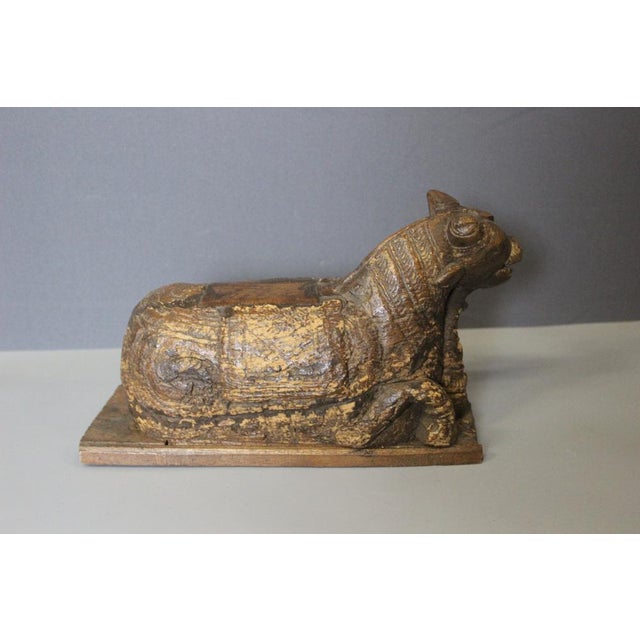 Sculpture depicting a reclining cow, carved from wood, origin India, 19th century, overall in good condition