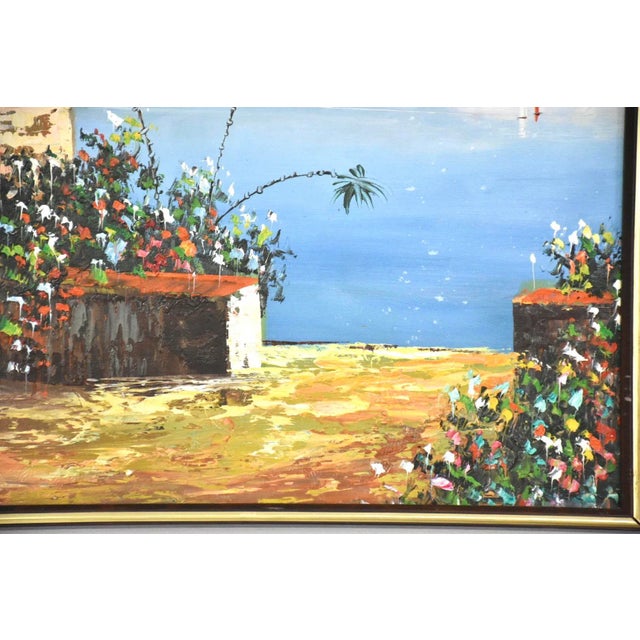 A stunning vibrant oil on canvas waterfront estate painting signed Rossini. Comes in a gold colored frame. 37” wide. 1”...
