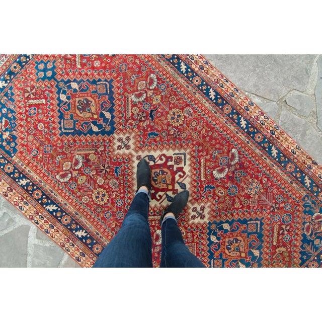 This stunning piece features colors such as maroon red, blue, peachy pink, ivory, pale yellow and deep red. The rug is...