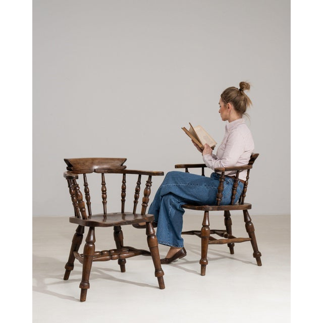 A pair of spindle-back armchairs whose dark wood, turned legs gives it real character at first glance. Dating to 1880s and...