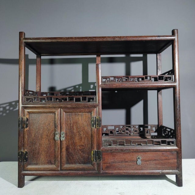 Add a touch of refined Chinese scholarship to your space with this exquisite vintage display cabinet. Crafted from dense...