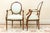 A refined pair of French Louis XVI Revival fauteuil armchairs crafted in warm-toned fruitwood and dating to the early...
