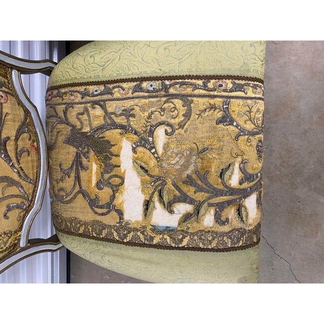 A pair of custom upholstered slipper chairs with beautiful antique embroidered textiles. The textiles have some pieces...
