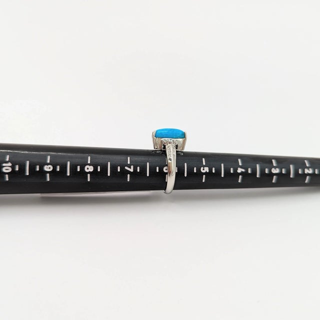 Beautiful turquoise oval cabochon with good quality white diamond rounds. Handmade in platinum. Ring size 5.75. Metal:...