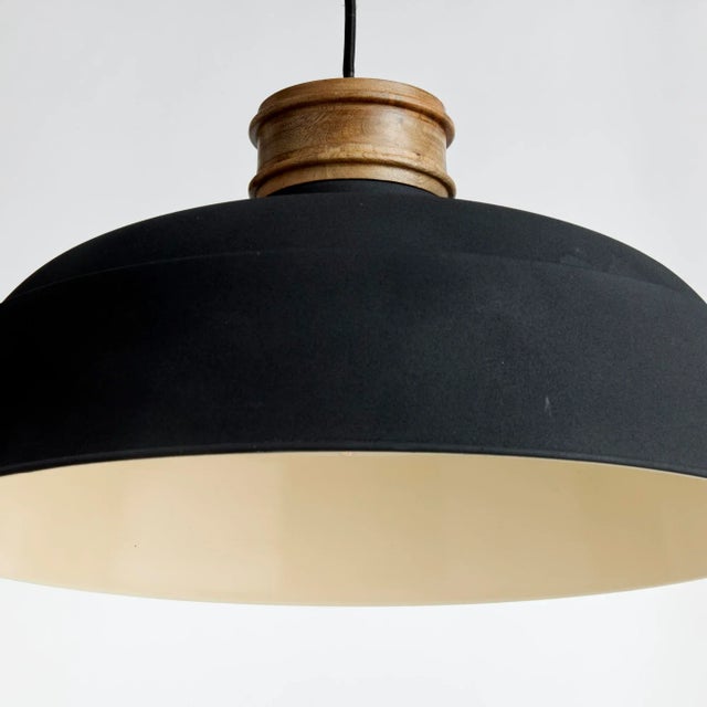This handsome pendant strikes the perfect balance of wood & metal. Illuminate the entryway, hall or kitchen table in...