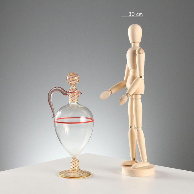 Blown glass amphora decanter with red and yellow glass filigree spiral decorations. This piece is attributed to the...