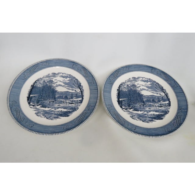 This charming Pair of Large Chop Plates is made of ceramic. It features a central motif of a group of workers keeping busy...