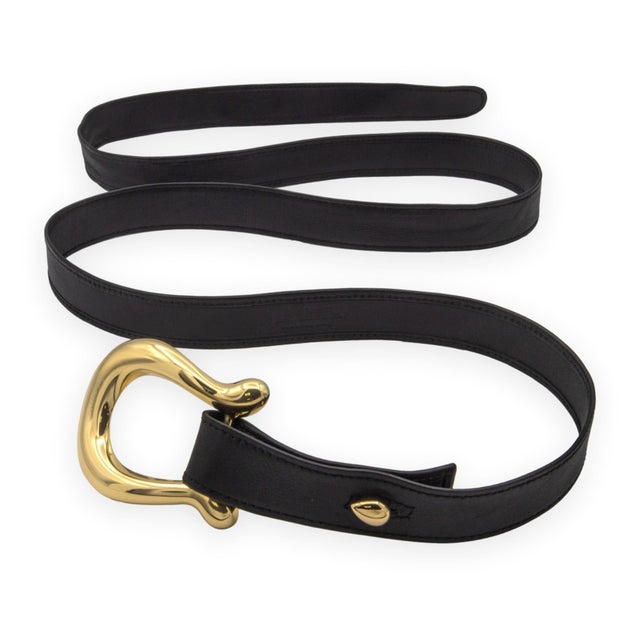A rare and substantial piece from Elsa Peretti's equestrian series for Tiffany & Co. — a full belt in black leather with a...