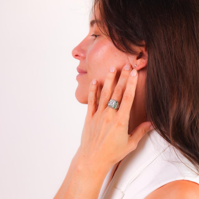 This Art Deco platinum ring sparkles with a GIA-certified 1.51 carat old mine diamond, accented by dazzling diamonds and...