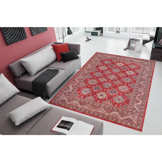 Enhance your home with this exquisite hand-knotted Super Kazak rug, crafted from fine hand-spun wool and dyed with all-...