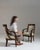 This pair of 19th century Empire upholstered armchairs from France, made in dark mahogany with scrolled arms and cream...