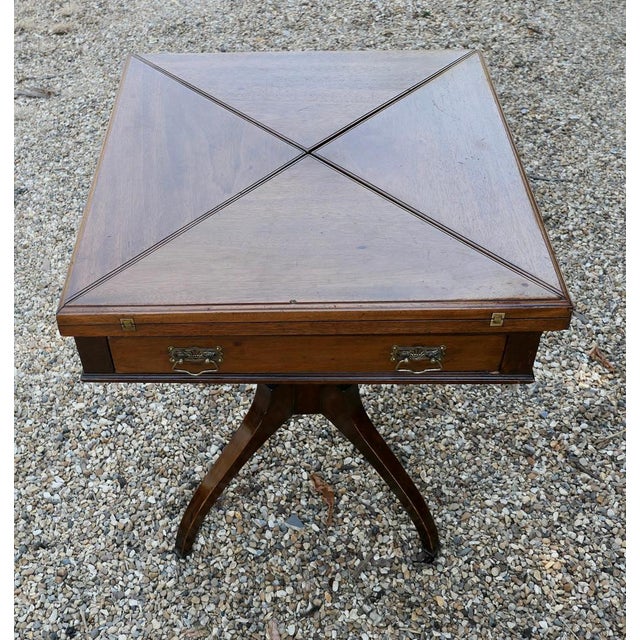Late Victorian envelope card table with gaming wells. A beautifully designed piece, the sturdy 4 footed leg supports the 4...