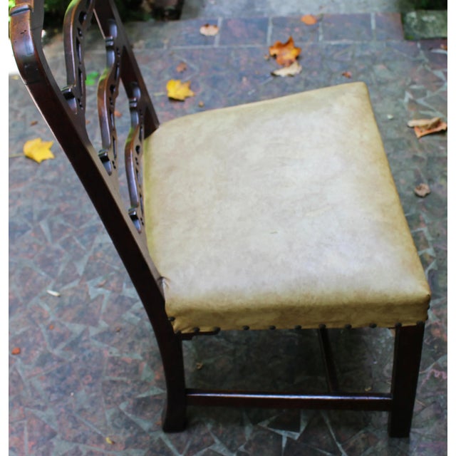 A George III side chair of good, sturdy size. English, c.1760, mahogany. The wavy ladder back with Gothic open cut-work...