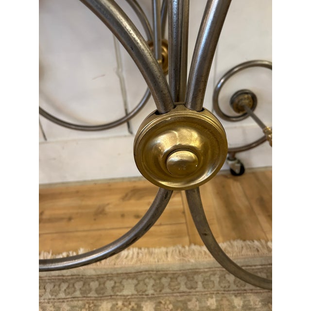 Versatile French steel and brass baker's table from the late 19th century with white marble top and scrolling legs....