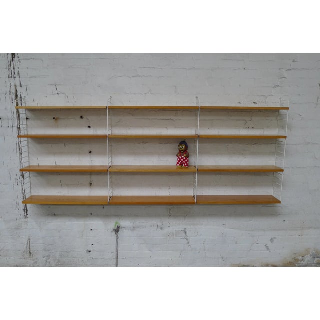 Design classics by Kajsa and Nils "Nisse" Strinning from 1949. modular shelving system with ash veneer shelves and white...