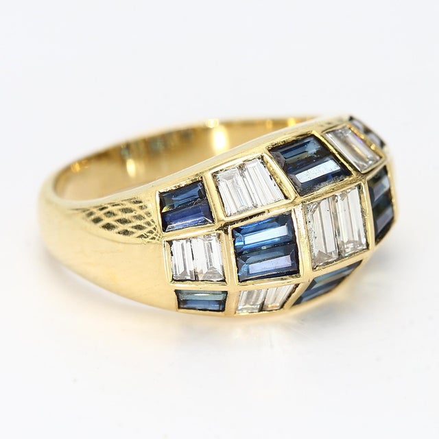 This 18k yellow gold ring has a checkerboard pattern made up of alternating diamond & blue sapphire baguettes. - Stone...