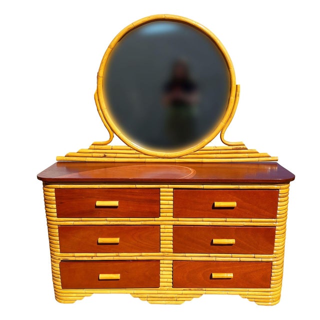 Restored Art Deco era rattan lowboy dresser with a mahogany top and six pull-out mahogany fronted drawers. The dresser is...