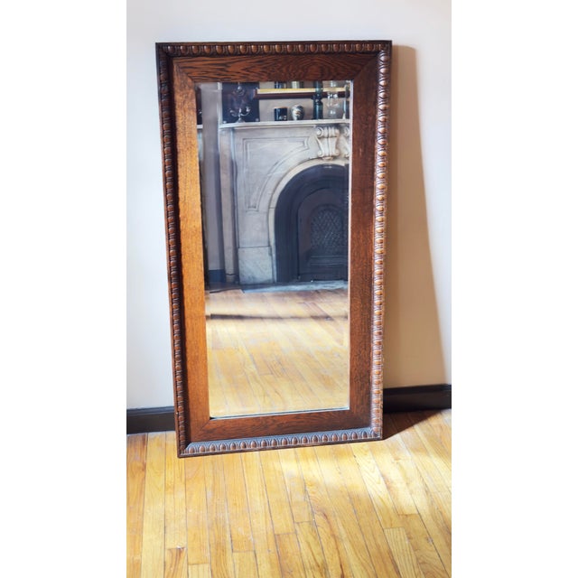Full-length mirror dating to the late Victorian Eastlake period. The frame is constructed of quarter-sawn oak, displaying...